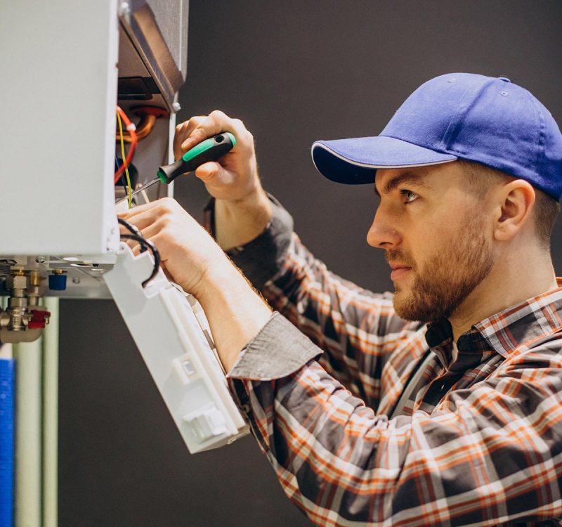 Service man adjusting house heating system